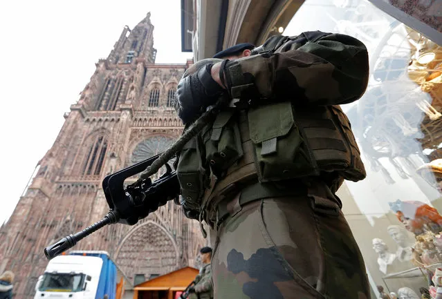A French soldier stands guard near Strasbourg's cathedral in Strasbourg, France, November 21, 2016. France said on Monday it had foiled a terrorist plot and arrested seven people, a year after a state of emergency was imposed to counter a wave of Islamist attacks. (Photo by Vincent Kessler/Reuters)