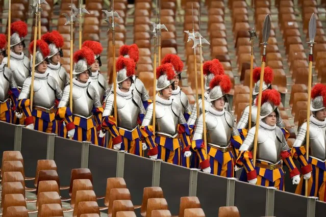 Vatican Swiss Guards arrive at the Pope Paul VI hall on the occasion of their swearing-in ceremony, at the Vatican, Friday, May 6, 2022. (Photo by Andrew Medichini/AP Photo)