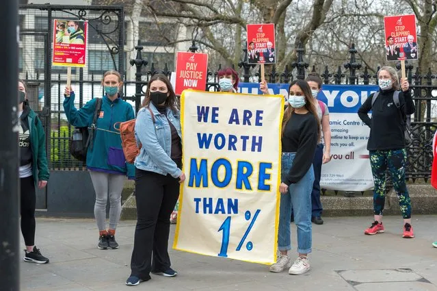 NHS staff stage a protest outside St Thomas' Hospital in central London to demand a 15% pay rise from the government, on 01 April, 2021 in London, England. The Department for Health and Social Care has recommended that NHS staff in England should receive a 1% pay increase this year despite the unprecedented pressure experienced by the health workers during the coronavirus pandemic. (Photo by WIktor Szymanowicz/NurPhoto/Rex Features/Shutterstock)