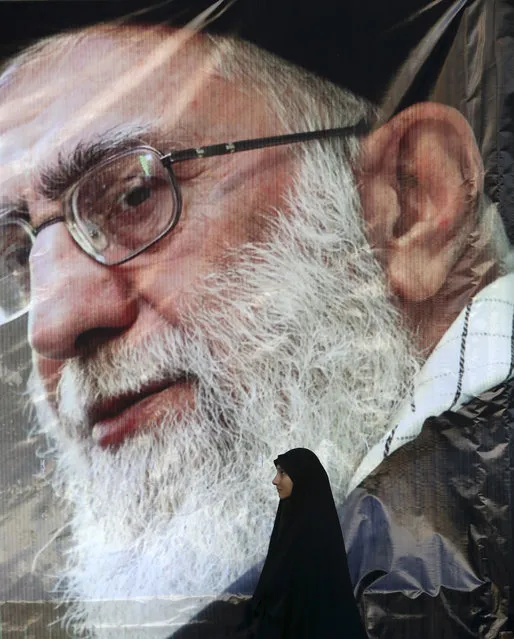 An Iranian woman stand under a portrait of the Supreme Leader Ayatollah Ali Khamenei at the conclusion of a rally to protest the execution last week of Sheikh Nimr al-Nimr, a prominent opposition Shiite cleric, shown in the posters, in Tehran, Iran, Monday, January 4, 2016. Allies of Saudi Arabia followed the kingdom's lead and began scaling back diplomatic ties to Iran on Monday after the ransacking of Saudi diplomatic missions in the Islamic Republic, violence sparked by the Saudi execution of al-Nimr. (Photo by Vahid Salemi/AP Photo)