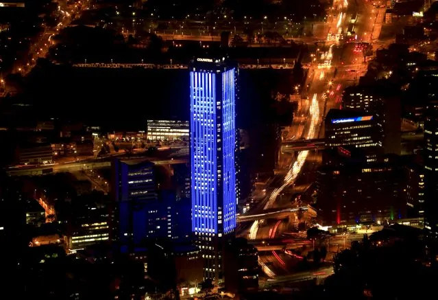 The Colpatria tower is pictured as it is lit up in blue to honor the 70th anniversary of the United Nations in Bogota, Colombia, October 23, 2015. (Photo by Jose Miguel Gomez/Reuters)