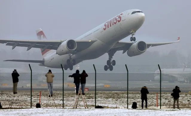 Plane spotters take pictures as an Airbus A333-300 passenger jet of Swiss arline takes off from Zurich Airport, Switzerland January 21, 2016. (Photo by Arnd Wiegmann/Reuters)