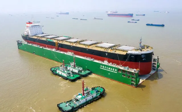The 80,000-ton bulk carrier GCL Luxembourg was launched into the Yangtze River by five high-powered tugboats in Suzhou, east China's Jiangsu Province, May 24, 2021. (Photo by Costfoto/Barcroft Media via Getty Images)