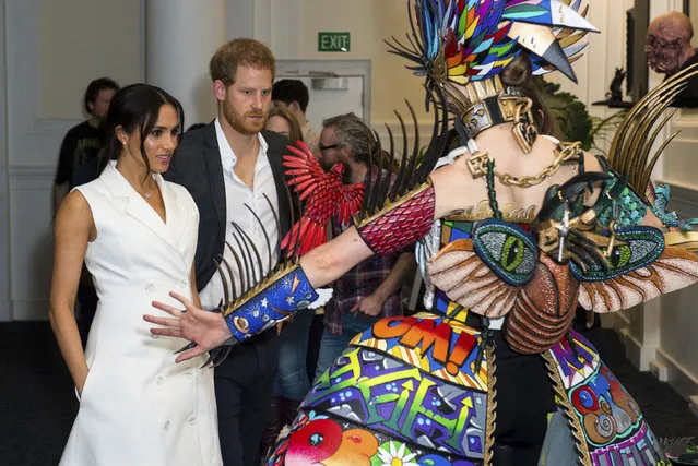 Britain's Prince Harry and Meghan, Duchess of Sussex meet actors in costume during a visit to Courtenay Creative in Wellington, New Zealand, Monday, October 29, 2018. Prince Harry and his wife Meghan are on day 14 of their 16-day tour of Australia and the South Pacific. (Photo by Dominic Lipinski/Pool Photo via AP Photo)