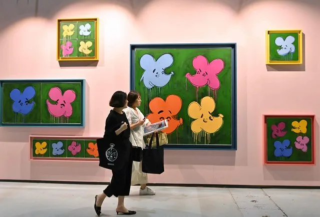 Visitors walk past an artwork named “Who are the Flowers?, 2023” by artist Simon Fujiwara during the Frieze Seoul 2023 art fair in Seoul on September 6, 2023. (Photo by Jung Yeon-je/AFP Photo)