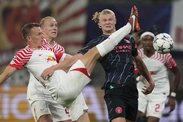 Manchester City's Erling Haaland, right, challenges for the ball with Leipzig's Lukas Klostermann during the Champions League group G soccer match between RB Leipzig and Manchester City in Leipzig, Germany, Wednesday, October 4, 2023. (Photo by Matthias Schrader/AP Photo)