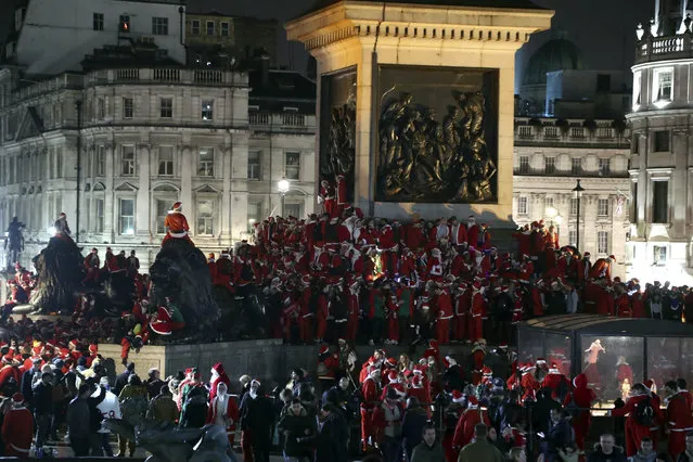People in Santa Claus costumes gather in Trafalgar Square as they take part in Santacon London 2018, in London, Saturday, December 8, 2018. (Photo by Gareth Fuller/PA Wire via AP Photo)