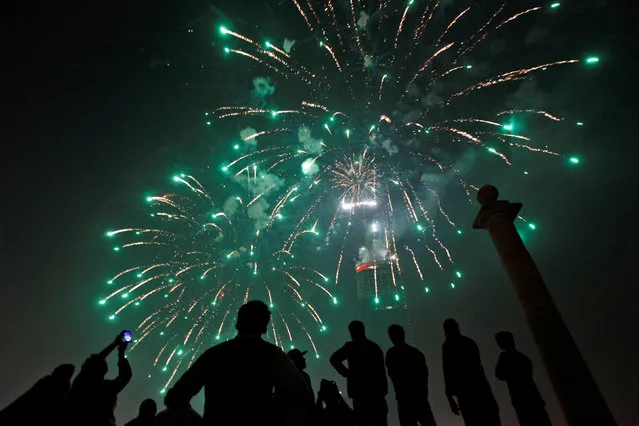 People gather to observe fireworks in celebration of the New Year in Karachi, Pakistan, January 1, 2017. (Photo by Akhtar Soomro/Reuters)