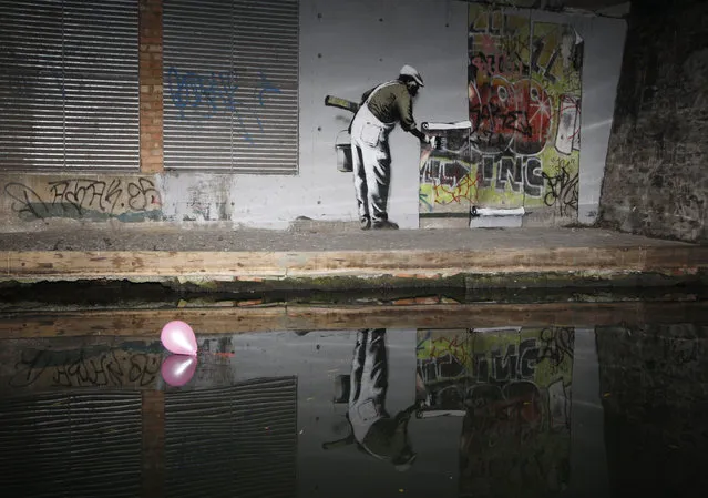 Graffiti art is seen on a wall next to the Regent's Canal, in Camden in London, December 22, 2009. British media have attributed the work to Banksy. (Photo by Luke MacGregor/Reuters)