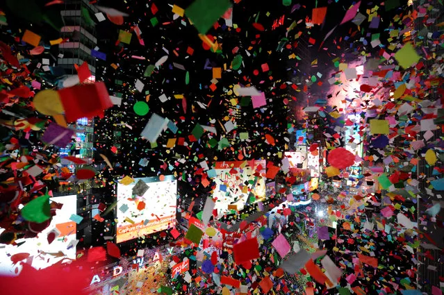 Confetti falls as the clock strikes midnight during New Year celebrations in Times Square in New York, January 1, 2017. (Photo by Mark Kauzlarich/Reuters)