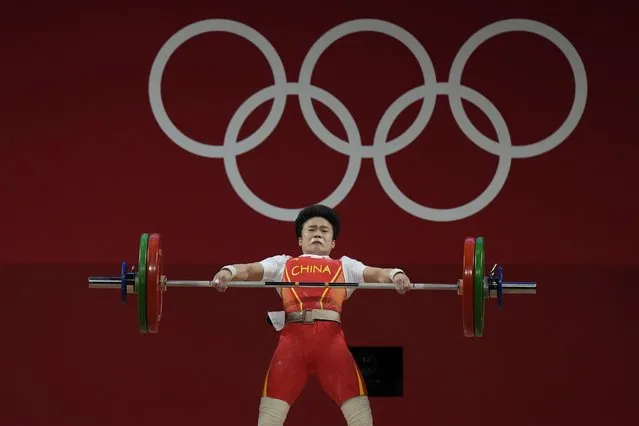Hou Zhihui of China competes in the women's 49kg weightlifting event, at the 2020 Summer Olympics, Saturday, July 24, 2021, in Tokyo, Japan. (Photo by Luca Bruno/AP Photo)