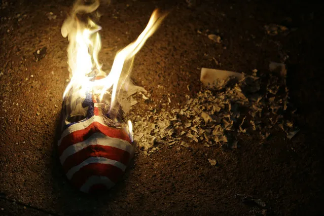 Protesters burn a mask painted as a U.S. flag during a rally in metropolitan Manila, Philippines on Friday, January 26, 2018. Manila's top diplomat has accused Human Rights Watch of deceiving the international community by making it appear “that the Philippines has become the Wild, Wild West of Asia where we just kill people left and right”. Foreign Secretary Alan Peter Cayetano demanded an apology from the U.S.-based rights group for reporting a larger number of drug suspects killed in President Rodrigo Duterte's crackdown on illegal drugs. (Photo by Aaron Favila/AP Photo)