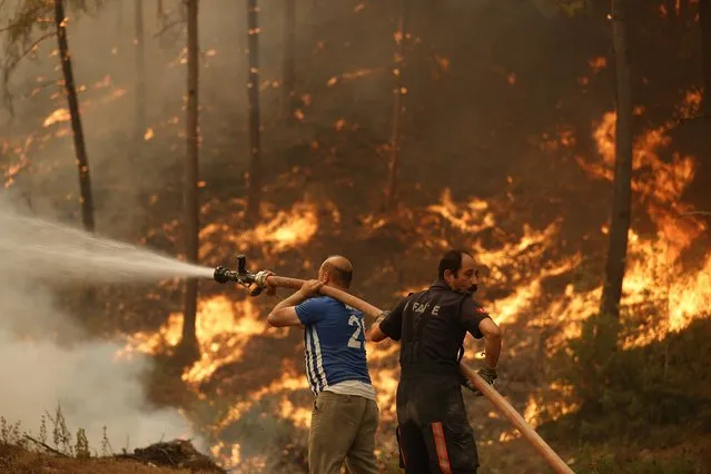 Works to extinguish the fire near Cardak neighbourhood of Manavgat district of Antalya, Turkey continue on August 03, 2021. Ground and air support works to extinguish the fire are underway. (Photo by Mustafa Ciftci/Anadolu Agency via Getty Images)