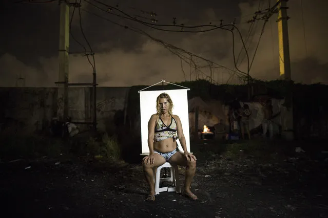 In this March 18, 2015 photo, Andrea, better known as Loira, which is the Portuguese word for 'blonde," poses for a portrait in an open-air crack cocaine market, known as a “cracolandia” or crackland where users can buy crack, and smoke it in plain sight, day or night, in Rio de Janeiro, Brazil. Andrea says she is married and has a home, but she keeps returning to crackland to feed her addiction. (Photo by Felipe Dana/AP Photo)
