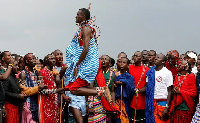 Tipape Lekatoo, a Maasai Moran from Mbirikani Manyatta, competes in a traditional high-jump event during the 2018 Maasai Olympics at the Sidai Oleng Wildlife Sanctuary, at the base of Mt. Kilimanjaro, near the Kenya-Tanzania border in Kimana, Kajiado, Kenya December 15, 2018. (Photo by Thomas Mukoya/Reuters)
