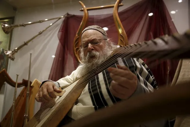U.S.-Israeli musicologist David Louis plays a lyre as part of a demonstration of biblical instruments at the Temple Institute in Jerusalem January 25, 2016. Louis is among experts trying to reconstruct the notes to which prayers were chanted at the ancient Jewish temples in the holy city, a liturgical art that skeptics believe is irretrievably lost. (Photo by Ronen Zvulun/Reuters)