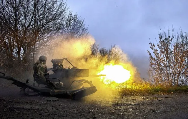 A member of Ukraine's National Guard fires an anti-aircraft gun at a position not far from Kharkiv, northeastern Ukraine, 11 November 2022, amid Russia's invasion. Kharkiv and surrounding areas have been the target of heavy shelling since February 2022, when Russian troops entered Ukraine starting a conflict that has provoked destruction and a humanitarian crisis. At the beginning of September, the Ukrainian army pushed Russian forces from occupied territory in the northeast of the country in counterattacks. (Photo by Sergey Kozlov/EPA/EFE)
