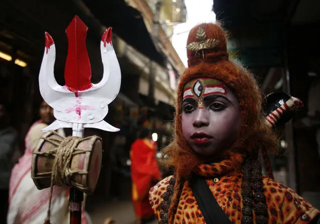 A boy dressed as Lord Shiva stands inside a temple during Mahashivratri festival in Trakeshawar, about 50 km (30 miles) west from Kolkata February 6, 2008. (Photo by Jayanta Shaw/Reuters)