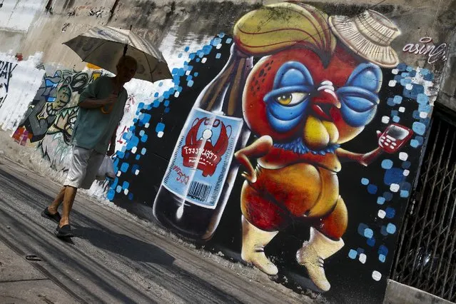 A man walks pass a wall mural painted by graffiti artist Asin Acid in Bangkok, Thailand, March 7, 2016. State repression has unleashed a wave of artistic expression, say artists and art lovers, and the Thai capital's art scene is blooming in response to life under junta rule. (Photo by Athit Perawongmetha/Reuters)