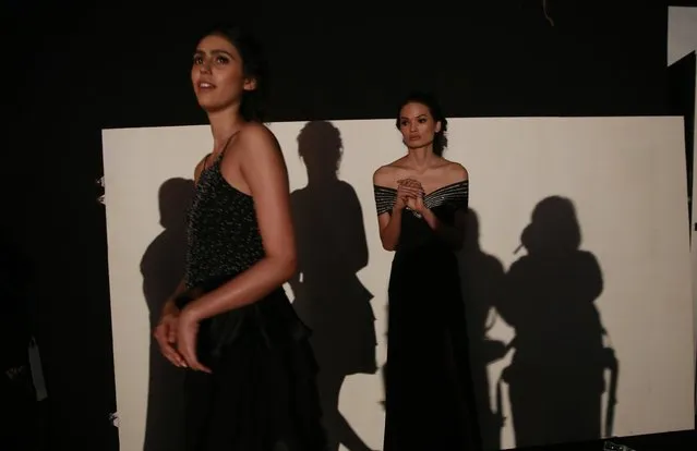 In this February 1, 2017 photo, Anjali Lama, right, a transgender model from Nepal, waits backstage for her turn to walk the ramp during Lakme Fashion week in Mumbai, India. (Photo by Rafiq Maqbool/AP Photo)