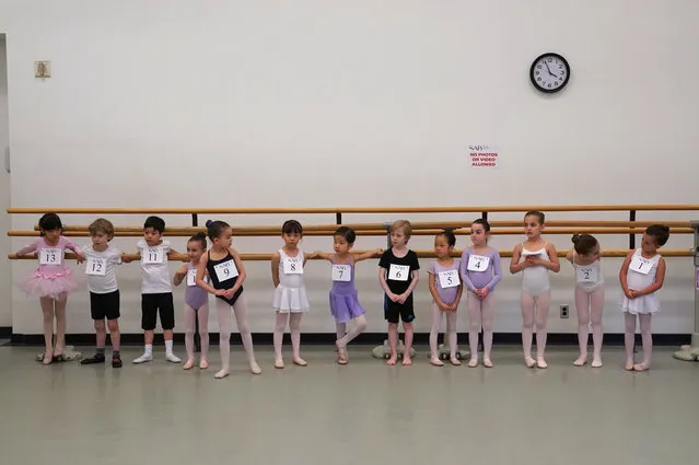 Children line up as they wait to audition as part of over one hundred six year olds that try out for spots in the world-renowned School of American Ballet at the School of American Ballet at the Lincoln Center in New York April 1, 2019. SAB's auditioners look for young girls and boys who are interested in pursuing ballet training and those selected start classes in the Fall. (Photo by Timothy A. Clary/AFP Photo)