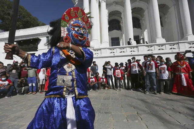 Masked dancers perform during the annual Indra Jatra festival in Kathmandu, Nepal, Sunday, September 19, 2021. (Photo by Niranjan Shrestha/AP Photo)