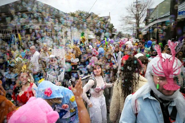 People walk in costumes during the Society of Saint Anne parade through Bywater and Marigny neighborhoods on Mardi Gras Day in New Orleans, Tuesday, February 13, 2024. (Photo by David Grunfeld/AP Photo)