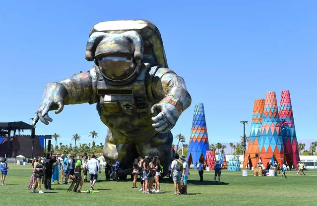 “Overview Effect” Sculpture by Poetic Kinetics is displayed in front of the “H.i.P.O.” Hazardus Interstellar Professional Operations sculpture by Debo Vabo displayed at Coachella Music Festival on April 13, 2019, in Indio, California. (Photo by Valerie Macon/AFP Photo)