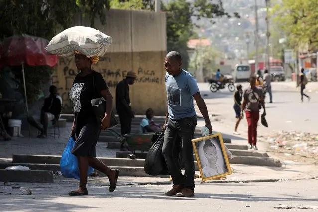Residents carry belongings as they flee their homes as the government declared state of emergency amid violence, in Port-au-Prince, Haiti, on March 4, 2024. (Photo by Ralph Tedy Erol/Reuters)