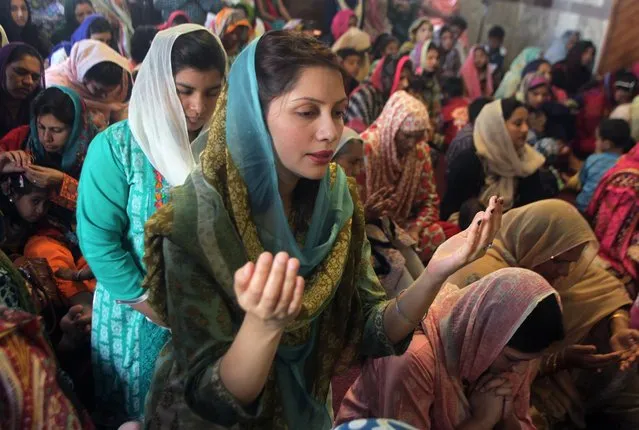 Christian women pray during an Easter service at St Anthony's Church in Lahore, Pakistan, Sunday, March 27, 2016. Christians across the world are celebrating Easter, commemorating the day followers believe Jesus was resurrected in Jerusalem over 2,000 years ago. (Photo by K.M. Chaudary/AP Photo)
