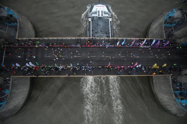 Runners of the London Marathon are seen from Tower Bridge’s Glass Floor during the Virgin Money London Marathon at United Kingdom on April 28, 2019 in London, England. (Photo by Toby Melville/Reuters)