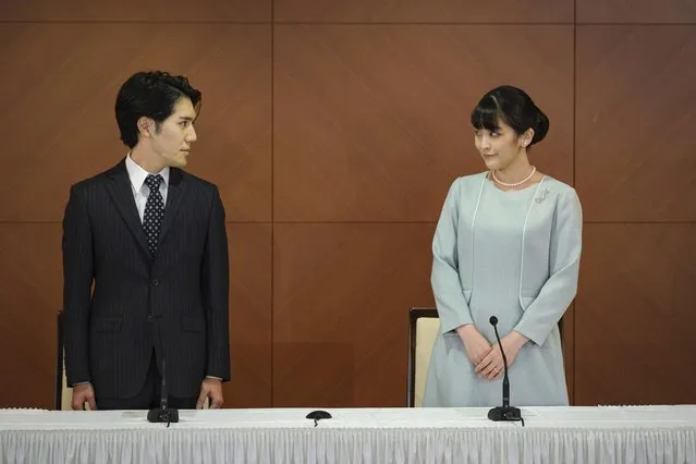 Japan's former Princess Mako, right, the elder daughter of Crown Prince Akishino and Crown Princess Kiko, and her husband Kei Komuro, look at each other during a press conference to announce their marriage at a hotel in Tokyo, Japan Tuesday, October 26, 2021. Former Princess Mako married the commoner and lost her royal status Tuesday in a union that has split public opinion after a three-year delay caused by a financial dispute involving her new mother-in-law. (Photo by Nicolas Datiche/Pool Photo via AP Photo)