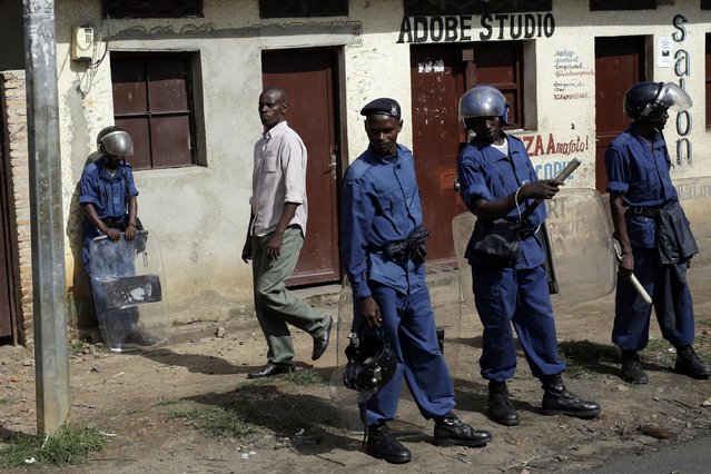 Police officers stand in the street after the barricades were cleared, in the district of Bujumbura, Burundi, Sunday  May 10, 2015. (Photo by Jerome Delay/AP Photo)