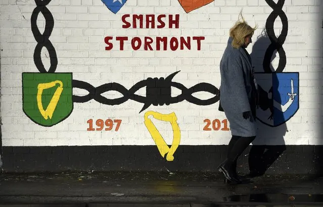 A woman walks past a mural on the Falls Road a day after Northern Ireland's Deputy First Minister Martin McGuinness resigned, throwing the devolved joint administration into crisis, in Belfast Northern Ireland, January 10, 2017. (Photo by Clodagh Kilcoyne/Reuters)
