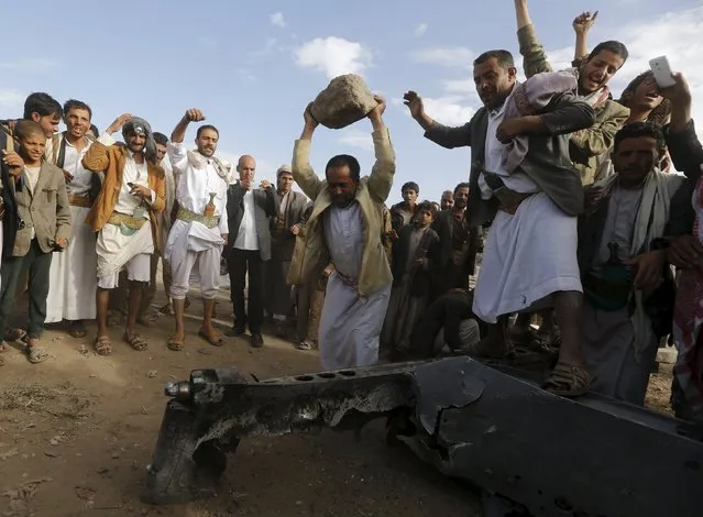 People destroy part of a Saudi fighter jet found in Bani Harith district north of Yemen's capital Sanaa May 24, 2015. (Photo by Khaled Abdullah/Reuters)