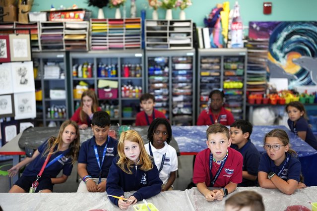 Third graders listen at the start of Lindsey Wuest's Science As Art class, at A.D. Henderson School in Boca Raton, Fla., Tuesday, April 16, 2024. When teachers at the K-8 public school, one of the top-performing schools in Florida, are asked how they succeed, one answer is universal: They have autonomy. (Photo by Rebecca Blackwell/AP Photo)