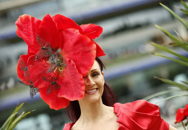 Chelsey Baker smiles as she poses for photographers on the second day of  Royal Ascot horse racing meet at Ascot, England, Wednesday, June 17, 2015. Royal Ascot is the annual five day horse race meeting that Britain's Queen Elizabeth II attends every day of the event.(AP Photo/Alastair Grant)