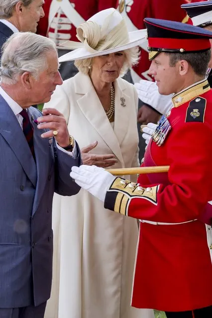Britain's Prince Charles and Camilla, the Duchess of Cornwall, speak with the troops during a ceremony for the opening of the Hougoumont farm as part of the bicentennial celebrations for the Battle of Waterloo, near Waterloo, Belgium June 17, 2015. The commemorations for the 200th anniversary of the Battle of Waterloo will take place in Belgium on June 19 and 20. REUTERS/Geert Vanden Wijngaert/Pool