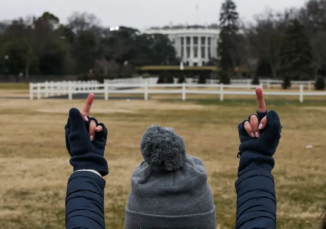 A protestor gestures toward the White House on the Ellipse near the South Lawn of the White House during the Women's March on Washington January 21, 2017 in Washington, DC. Large crowds are attending the anti-Trump rally a day after U.S. President Donald Trump was sworn in as the 45th U.S. president. (Photo by Drew Angerer/Getty Images)
