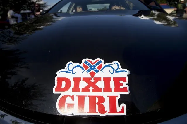 A woman drives a car with a “Dixie Girl” sticker on the hood before for a “Ride for Pride” event to show support for the Confederate flag in Brandon, Hillsborough County, June 26, 2015. (Photo by Carlo Allegri/Reuters)
