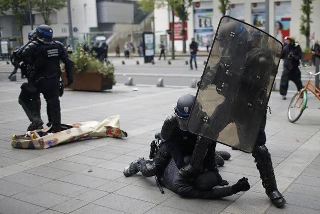 French riot police officers detain a protestor during a demonstration against the French labour law proposal in Nantes, France, as part of a nationwide labor reform protests and strikes, April 28, 2016. (Photo by Stephane Mahe/Reuters)