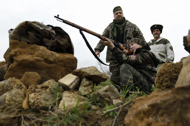 Students from the General Yermolov Cadet School take part in weapons training during a two-day field exercise near the village of Sengileyevskoye, just outside the south Russian city of Stavropol, April 13, 2014. (Photo by Eduard Korniyenko/Reuters)