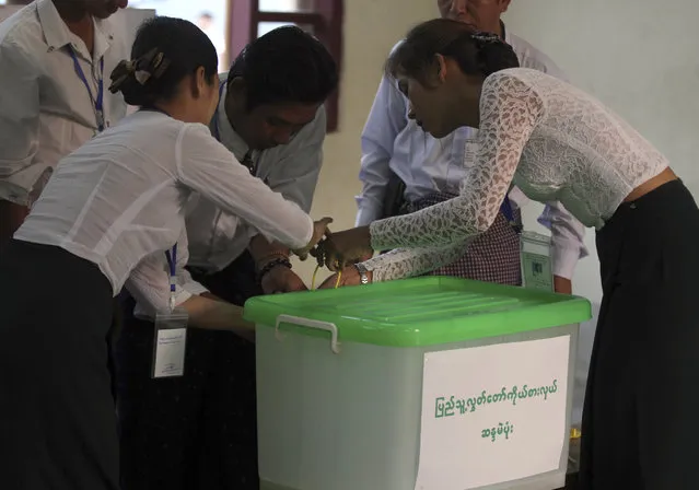 Officials of the Union Election Commission seal an empty box as they prepare to open a polling station on the outskirts of Yangon, Myanmar, Saturday, April 1, 2017. By-election began Saturday for 19 vacant parliament seats. (Photo by Thein Zaw/AP Photo)