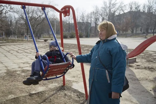 A child on a swing with his grandmother on February 16, 2022 in Prymorsk, Ukraine. Russian forces are conducting large-scale military exercises in Belarus, across Ukraine's northern border, amid a tense diplomatic standoff between Russia and Ukraine's Western allies. Ukraine has warned that it is virtually encircled, with Russian troops massed on its northern, eastern and southern borders. The United States and other NATO countries have issued urgent alerts about a potential Russian invasion, hoping to deter Vladimir Putin by exposing his plans, while trying to negotiate a diplomatic solution. (Photo by Pierre Crom/Getty Images)