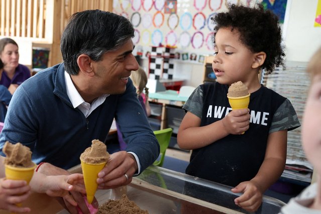 Britain's Prime Minister and Conservative Party leader, Rishi Sunak, interacts with children during his visit to the Imagination Childcare centre in Swindon, western England on June 7, 2024 during a campaign event in the build-up to the UK general election on July 4. (Photo by Phil Noble/AFP Photo)