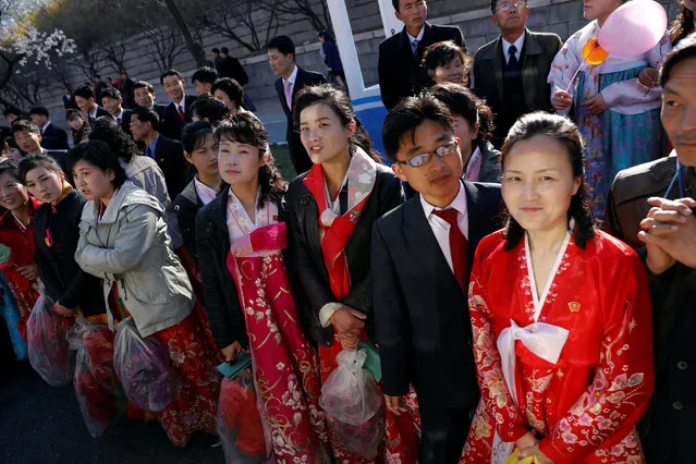 People react as a vehicle carrying foreign reporters passes towards the newly constructed residential complex before its opening in Ryomyong street in Pyongyang, North Korea April 13, 2017. (Photo by Damir Sagolj/Reuters)