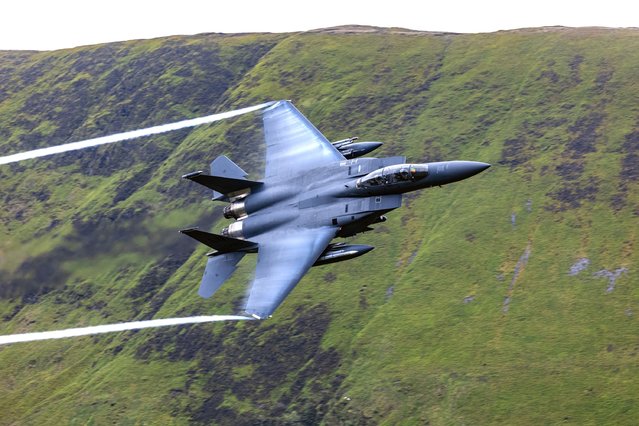 USAF F-15 out of RAF Lakenheath flying The Mach Loop Wales on June 12, 2024. The Mach Loop is a series of valleys in the United Kingdom in west-central Wales, notable for their use as low-level training areas for fast aircraft. The system of valleys lies 13 km east of Barmouth between the towns of Dolgellau to the north and Machynlleth to the south, from the latter of which it takes its name. The training area is part of the United Kingdom Low Flying System and lies within Low Flying Area 7, which covers all of Wales. (Photo by CelebrityPhotosUK/Cover Images)