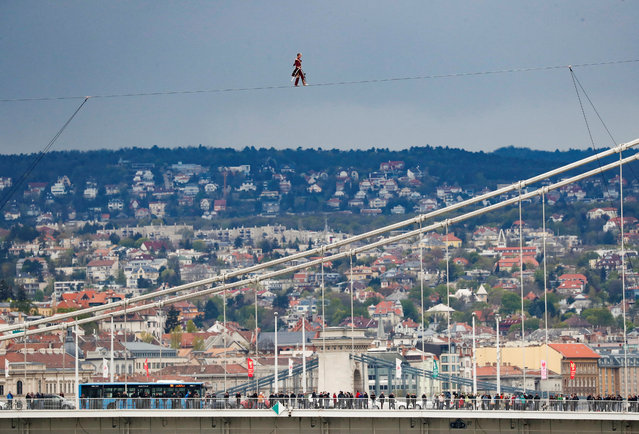 Hungarian artist Laszlo Simet Jr. walks across the Danube River from one bank to the other on a wire rope, 30 meters above the river, on the World Circus Day in Budapest, Hungary on April 15, 2023. (Photo by Bernadett Szabo/Reuters)