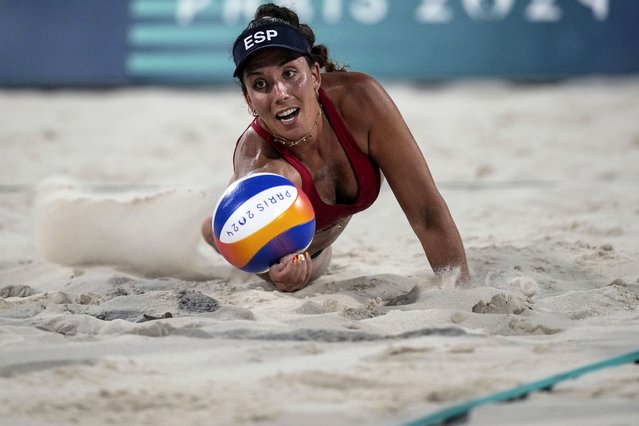 Spain's Paula Soria Gutierrez dives for the ball during the women's pool A beach volleyball match between Brazil and Spain at Eiffel Tower Stadium at the 2024 Summer Olympics, Tuesday, July 30, 2024, in Paris, France. (Photo by Louise Delmotte/AP Photo)