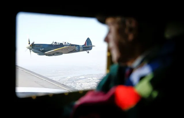 A WWII Spitfire can be seen out the window of a C47 A Dakota plane, while veteran Roy Briggs looks on, during Remembrance Sunday celebrations in Dover, Britain, November 10, 2019. (Photo by Henry Nicholls/Reuters)